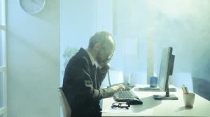 stock-footage-businessman-wearing-gas-mask-working-in-his-office